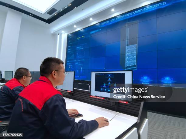 Staff members work at an intelligent control center of the China Telecom Digital Qinghai Green Big Data Center on October 11, 2023 in Haidong,...