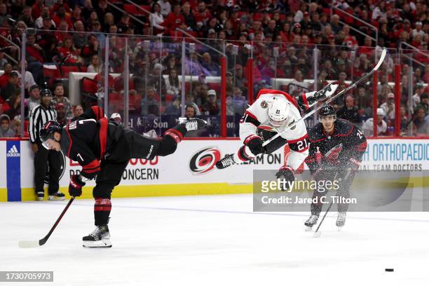 Mathieu Joseph of the Ottawa Senators is checked by Dmitry Orlov of the Carolina Hurricanes during the third period of their game at PNC Arena on...