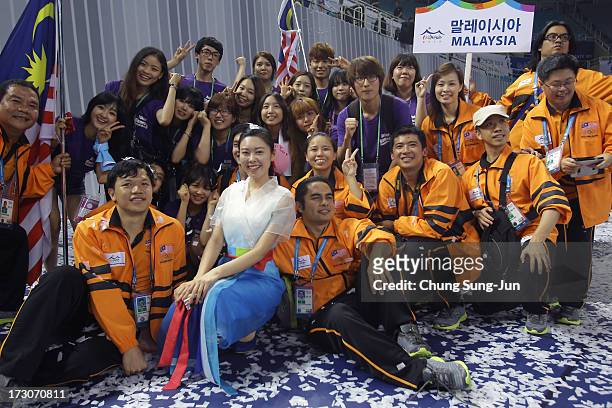 Team Malaysia and volunteers celebrate during the closing ceremony of the 4th Asian Indoor & Martial Arts Games at Incheon Samsan World Gymansium on...