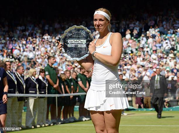 Sabine Lisicki poses with the runner-up trophy after being beaten by Marion Bartoli in the Ladies Singles Final on Day 12 of the Wimbledon Lawn...