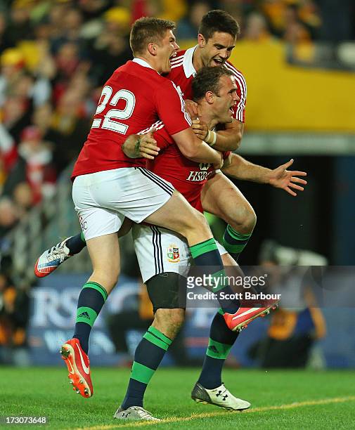 Jamie Roberts of the Lions is mobbed by team mates Conor Murray and George North after scoring the Lions fourth try during the International Test...