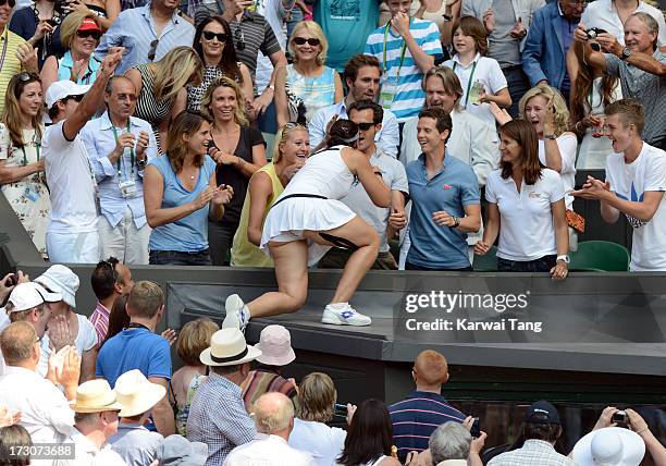 Marion Bartoli climbs up to the family box after beating Sabine Lisicki in the Ladies Singles Final on Day 12 of the Wimbledon Lawn Tennis...