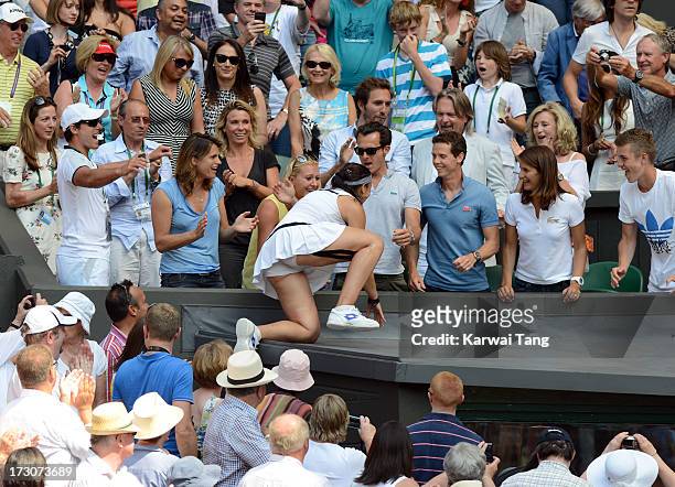 Marion Bartoli climbs up to the family box after beating Sabine Lisicki in the Ladies Singles Final on Day 12 of the Wimbledon Lawn Tennis...