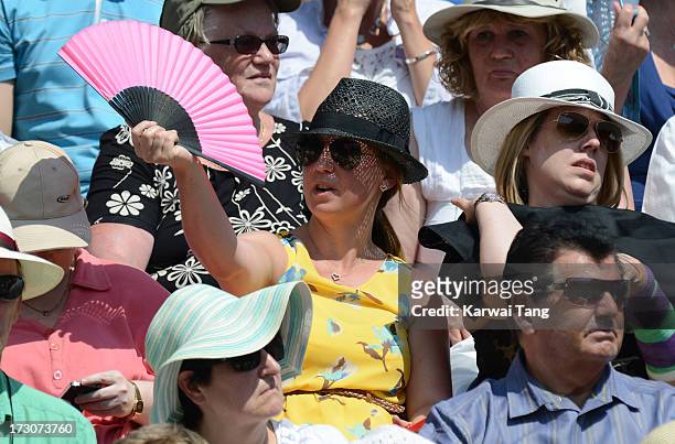 Spectators fanning themselves at the Ladies Singles Final on Day 12 of the Wimbledon Lawn Tennis Championships at the All England Lawn Tennis and...