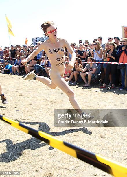 Festival-goers participate in a naked run to win next years tickets on Day 3 of the Roskilde Festival on July 6, 2013 in Roskilde, Denmark.