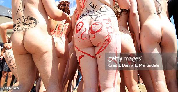 Naked festival-goers are seen on Day 3 of the Roskilde Festival on July 6, 2013 in Roskilde, Denmark.