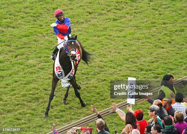 Manga Khumalo on Heavy Metal celebrates after winning the President's Champions Challenge; the main race during the 2013 Vodacom Durban July at...