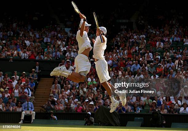 Mike Bryan and Bob Bryan of the United States of America bump chests as they celebrate match point during their Gentlemen's Doubles final match...