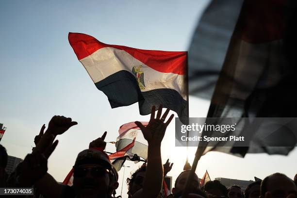 Protesters opposed to ousted Egyptian President Mohamed Morsi celebrate in Tahrir Square on July 6, 2013 in Cairo, Egypt. Over 17 people were killed...