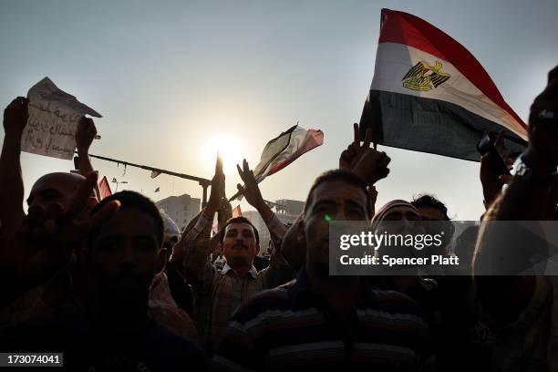 Protesters opposed to ousted Egyptian President Mohamed Morsi celebrate in Tahrir Square on July 6, 2013 in Cairo, Egypt. Over 17 people were killed...