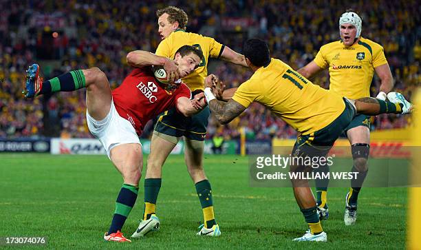 British and Irish Lions winger George North catches the ball as Australian Wallabies winger Joe Tomane contests, as his teammate Jesse Mogg and Ben...