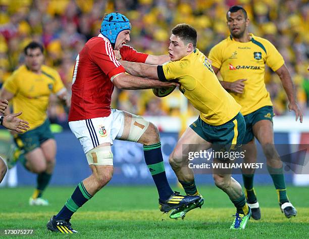 British and Irish Lions player Justin Tipuric tackles Australian Wallabies flyhalf James O'Connor as he teammate Kurtley Beales supports in the third...