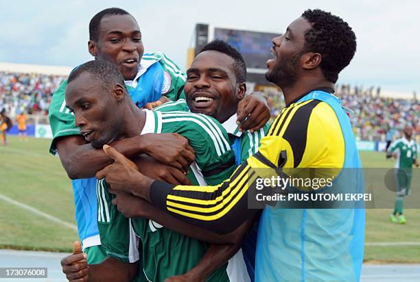 Nigerian attacker Mohammad Gambo is congratulated by his teammates after scoring a goal against Ivory Coast during the 2014 African Nations...
