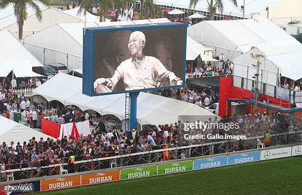 Giant screen projects images of former president Nelson Mandela during the 2013 Vodacom Durban July at Greyville Racecourse on July 06, 2013 in...