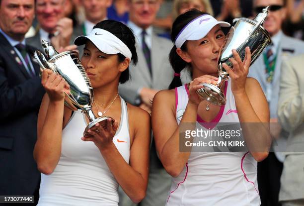 China's Peng Shuai and Taiwan's Hsieh Su-Wei pose with the winners trophies after beating Australia's Ashleigh Barty and her partner Australia's...