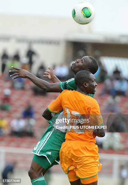 Nigerian attacker Mohammad Gambo vies for the ball with Ivorian defender Mathias Kassi during the 2014 African Nations Championship qualification...