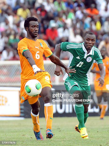Nigerian attacker Mohammad Gambo vies for the ball with Ivorian defender Baresi Gloudoueu during their 2014 African Nations Championship...
