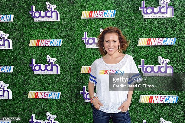 Actress Alyssa Milano poses for a photo at a VIP Event at The Terrace at International Motorsports Center during the NASCAR Sprint Cup Series Coke...