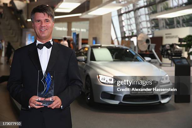 Harald Krueger, Board of Management member for Production of BMW AG poses with the Bavarian Sportaward 2013 after the Bavarian Sport Award gala at...