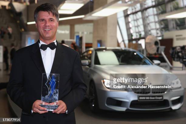 Harald Krueger, Board of Management member for Production of BMW AG poses with the Bavarian Sportaward 2013 after the Bavarian Sport Award gala at...