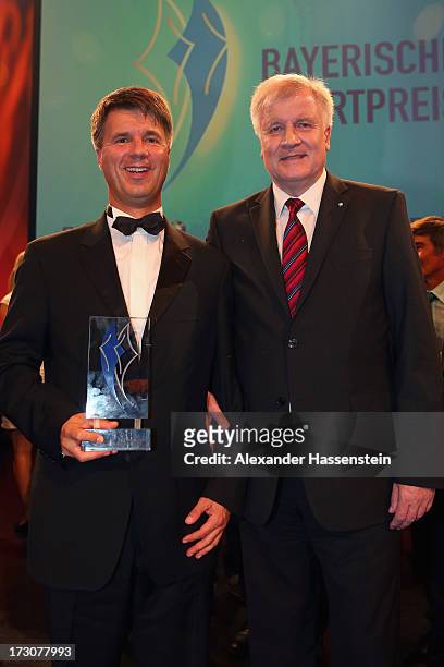 Harald Krueger, Board of Management member for Production of BMW AG poses with Bavarian state governor Horst Seehofer , after receiving the Bavarian...