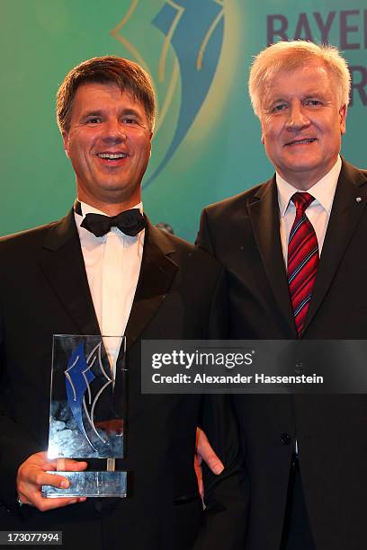 Harald Krueger, Board of Management member for Production of BMW AG poses with Bavarian state governor Horst Seehofer , after receiving the Bavarian...