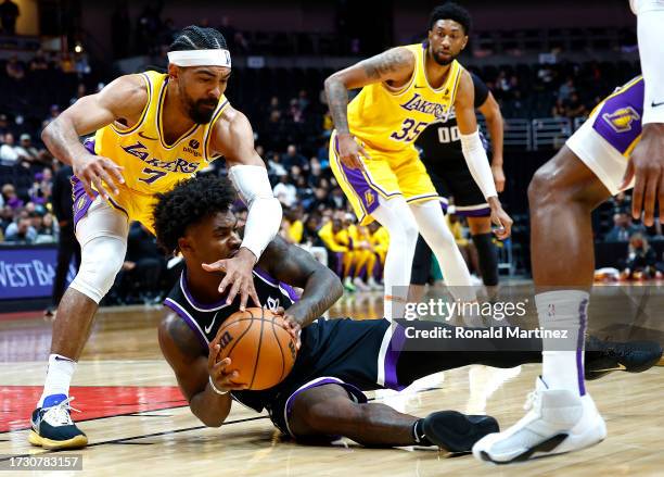 Davion Mitchell of the Sacramento Kings dives for the ball against Gabe Vincent of the Los Angeles Lakers in the first half at Honda Center on...