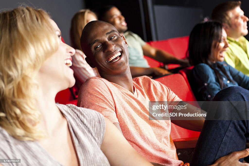 Happy couple laughing together at a theater