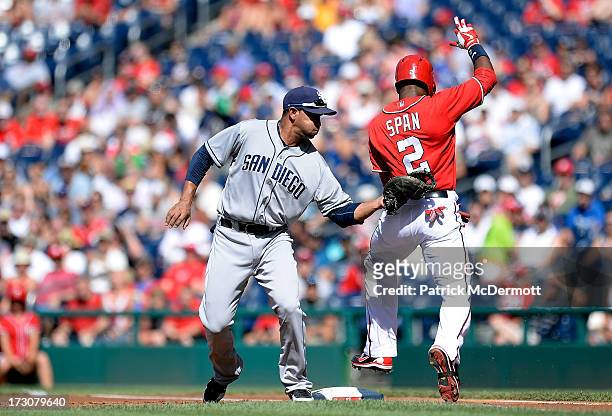 Denard Span of the Washington Nationals is tagged out by Jesus Guzman of the San Diego Padres at first base during the first inning of a game at...