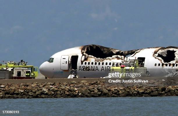 Boeing 777 airplane lies burned on the runway after it crashed landed at San Francisco International Airport July 6, 2013 in San Francisco,...