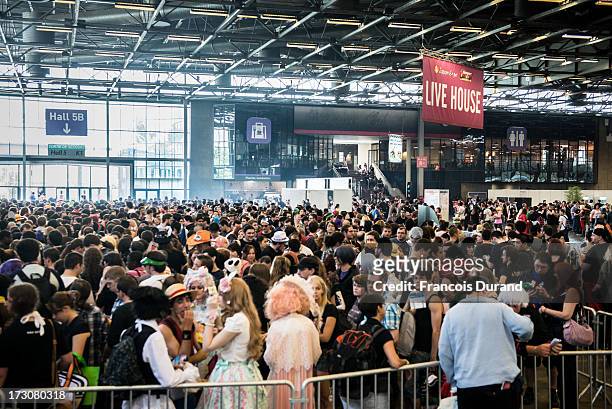 People queue ahead the JE live house 'TOYOTA x STUDIO4AC meets ANA PES' concert during the Japan Expo at Paris-nord Villepinte Exhibition Center on...