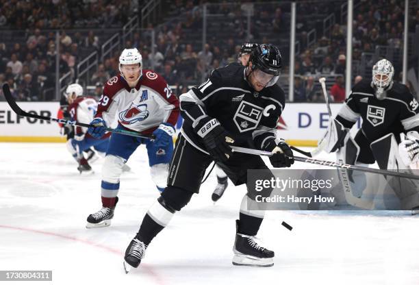 Anze Kopitar of the Los Angeles Kings collects a rebound in front of Nathan MacKinnon of the Colorado Avalanche during the first period in the Los...