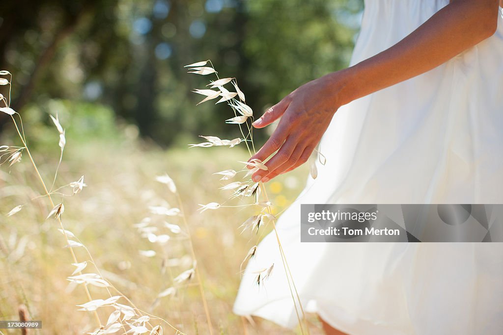 Woman walking through field