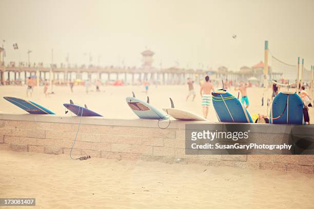 surfboards and hazy day at the beach - huntington beach kalifornien stock-fotos und bilder