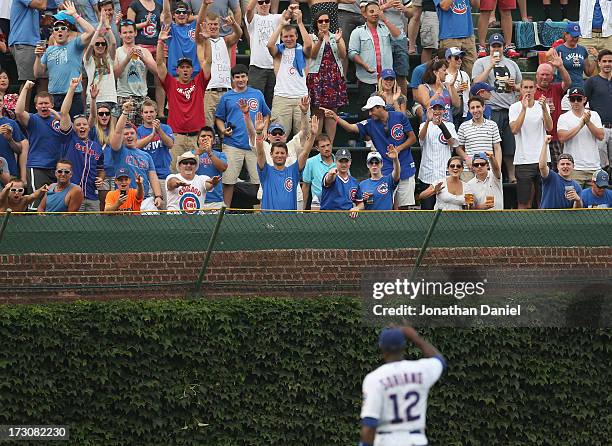 Fan cheer Alfonso Soriano of the Chicago Cubs after hitting his second two-run home run of the game in the 5th inning against the Pittsburgh Pirates...