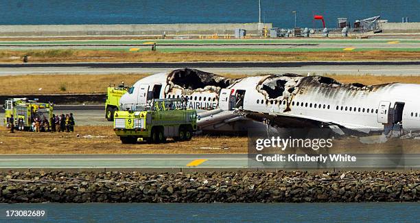 The remains of a Boeing 777 airplane lie on the tarmac after it crashed while landing at San Francisco International Airport July 6, 2013 in San...
