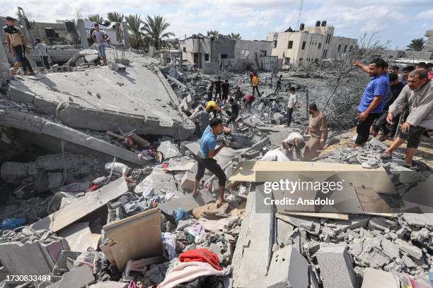 Civil defense teams and residents continue search and rescue operation around the buildings that were destroyed after Israel's attacks on the Gaza...