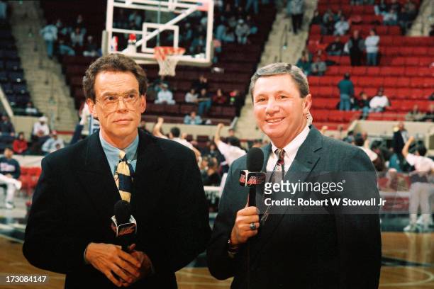 Sports announcers Mike Gorman and Dom Perno stand on the court during a pre-game analysis, Hartford, Connecticut, 1994.