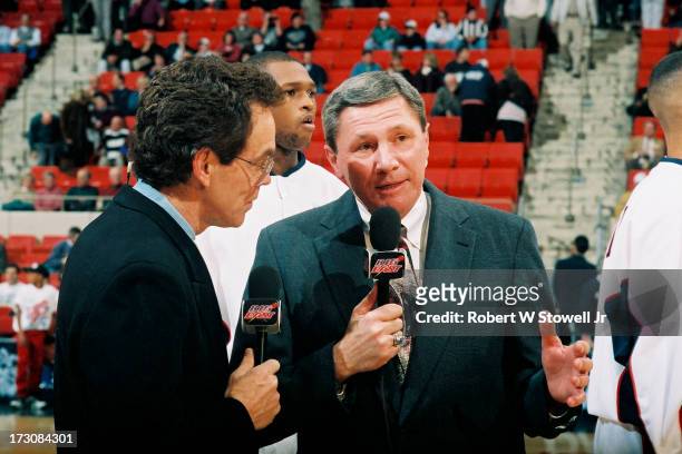 Sports announcers Mike Gorman and Dom Perno talk on the court during a pre-game analysis, Hartford, Connecticut, 1994.