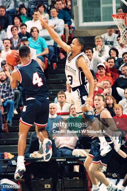 University of Connecticut basketball player Chris Smith jumps to block an opponant's shot, Storrs, Connecticut, 1994.