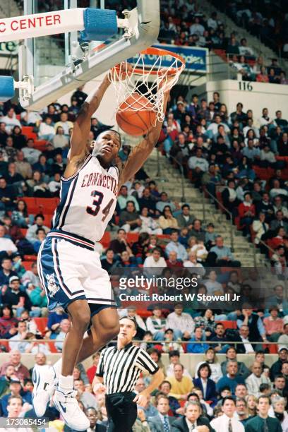 University of Connecticut basketball player Ray Allen hangs from the hoop during a game, Hartford, Connecticut, 1994.