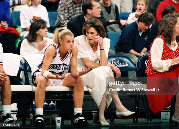 University of Connecticut basketball player Pam Weber listens to assistant coach Chris Dailey on the bench during a game, Storrs, Connecticut, 1995.