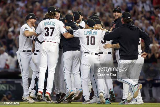 The Arizona Diamondbacks celebrate after beating the Los Angeles Dodgers 4-2 in Game Three of the Division Series at Chase Field on October 11, 2023...