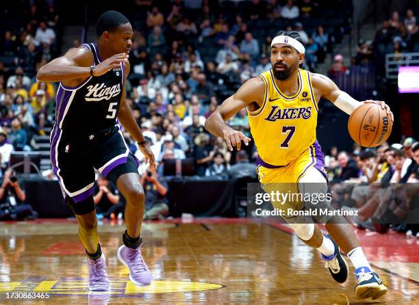 Gabe Vincent of the Los Angeles Lakers controls the ball against De'Aaron Fox of the Sacramento Kings in the second half at Honda Center on October...