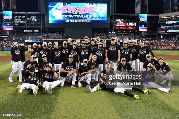 The Arizona Diamondbacks pose for photos after beating the Los Angeles Dodgers 4-2 in Game Three of the Division Series at Chase Field on October 11,...