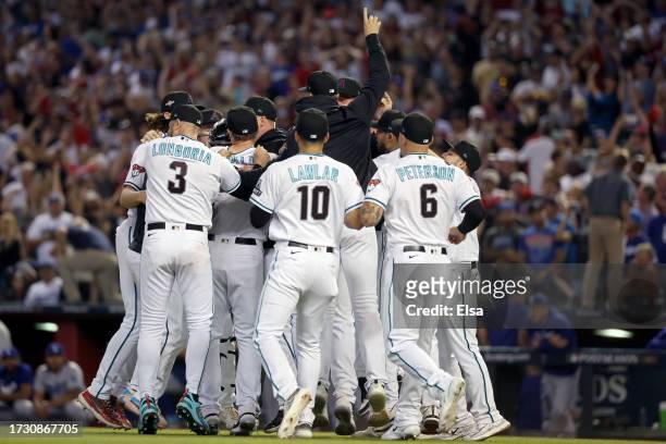 The Arizona Diamondbacks celebrate after beating the Los Angeles Dodgers 4-2 in Game Three of the Division Series at Chase Field on October 11, 2023...