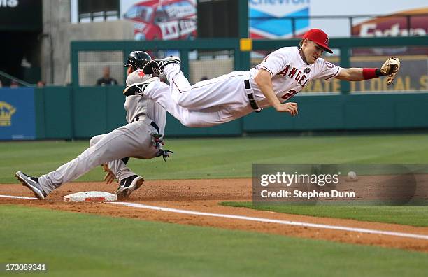 Third baseman Brendan Harris of the Los Angeles Angels of Anaheim can't reach a throw from catcher Chris Ianetta as jacooby Ellsworth of the Boston...