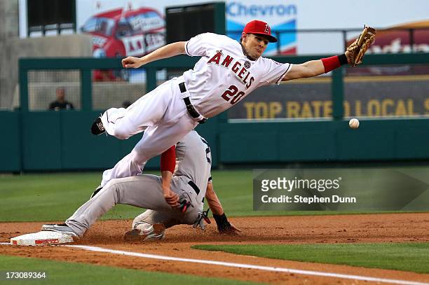 Third baseman Brendan Harris of the Los Angeles Angels of Anaheim can't reach a throw from catcher Chris Ianetta as jacooby Ellsworth of the Boston...