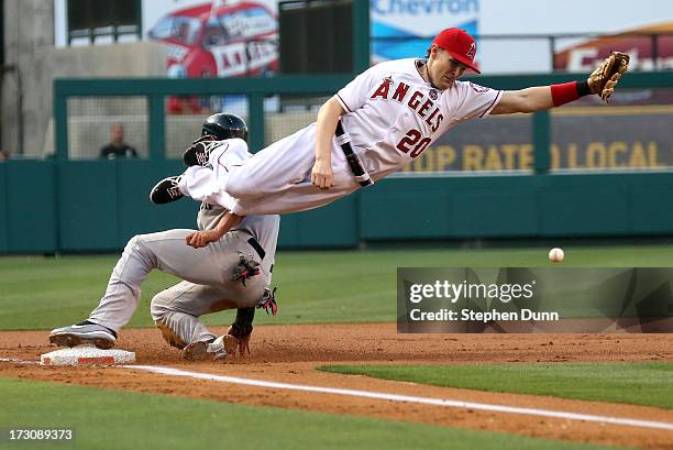 Third baseman Brendan Harris of the Los Angeles Angels of Anaheim can't reach a throw from catcher Chris Ianetta as jacooby Ellsworth of the Boston...