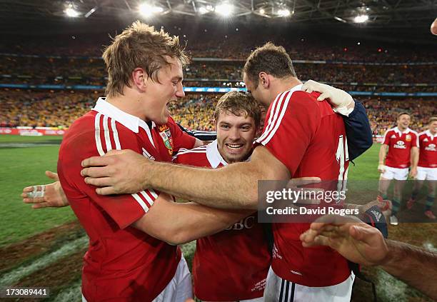 Leigh Halfpenny of the Lions celebrates with team mates Jonathan Davies and Jamie Roberts after their victory during the International Test match...